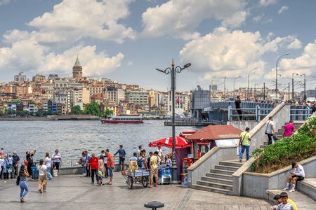 Istambul, Turkey â 07.13.2019. Many people on the Eminonu Embankment near the Galata bridge in Istanbul, on a sunny summer dayのeditorial素材
