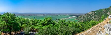Panoramic top view from the side of the ancient city of Priene, Turkey, on a sunny summer day. Big panoramic shot.の写真素材