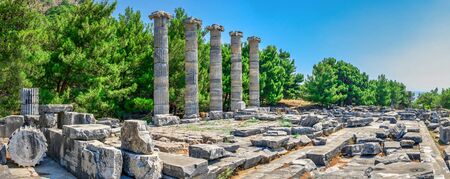 Ruins of the Temple of Athena Polias in the ancient city of Priene, Turkey, on a sunny summer day. Big panoramic shot.の写真素材