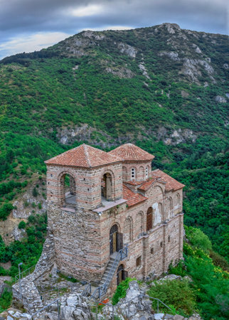 Asenovgrad, Bulgaria 07/24/2019. Church of the holy mother of God in the Asens Fortress surrounded Bulgarian Rhodope mountains on a cloudy summer dayのeditorial素材