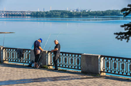 Dnipro, Ukraine 07.18.2020. Fishermans on the Dnipro embankment on a sunny summer morningのeditorial素材