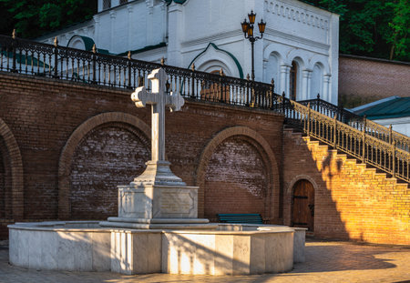 Svyatogorsk, Ukraine 07.16.2020. Memorial cross at the entrance to the Assumption Cathedral in the Svyatogorsk Lavra on a sunny summer morningのeditorial素材