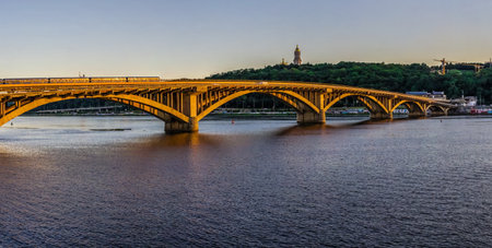 Kyiv, Ukraine 07.11. Kyiv Metro bridge across the Dnieper river on a sunny summer evening.のeditorial素材