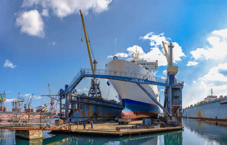 Chernomorsk, Ukraine. 03/21/2021. Large ship in dry dock of the Chernomorsk Shipyard on a sunny spring dayのeditorial素材