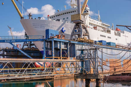 Chernomorsk, Ukraine. 03/21/2021. Large ship in dry dock of the Chernomorsk Shipyard on a sunny...