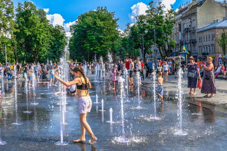 Lviv, Ukraine 07.07.2021. Fountain naer the Lviv State Academic Theater of Opera and Ballet on a sunny summer dayのeditorial素材