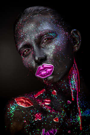 Mystical woman makeup with sparkles and luminous elements on a dark backgroundの写真素材