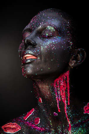 Mystical woman makeup with sparkles and luminous elements on a dark backgroundの写真素材
