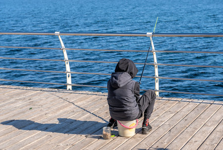 Odessa, Ukraine 28.10.2022. Fishermen on the pier of the Lanzheron embankment in Odessa, Ukraine, on...