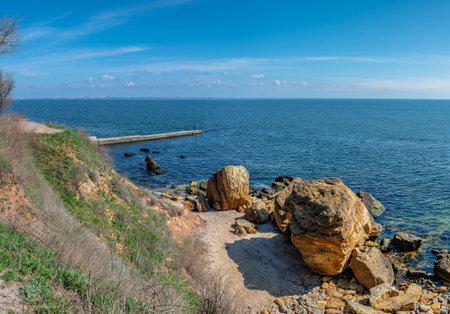 Coast of the Black Sea at the Wild Beach in Odessa, Ukraine, on a sunny spring dayの写真素材
