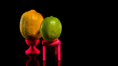 Creative still life with lemon and lime on a black backgroundの写真素材