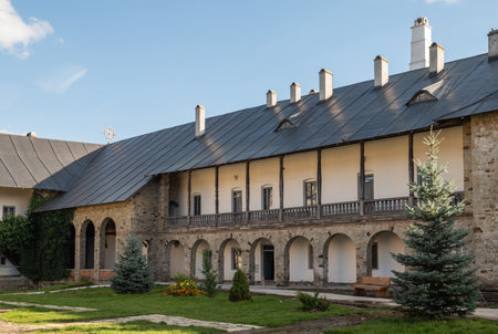 Neamt Monastery, Romania â October 15.2025. A view of the historic monastic quarters at Neamt Monastery. Stone galleries and arches reflect the centuries-old architecture and traditions of monastic life in Romaniaのeditorial素材