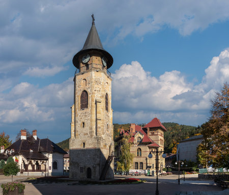 Piatra Neamt, Romania 10/16/2025. Full-height view of the Turnul lui Stefan cel Mare, the 15th-century belfry of Piatra Neamt's Princely Court, standing beside traditional historical buildingsのeditorial素材