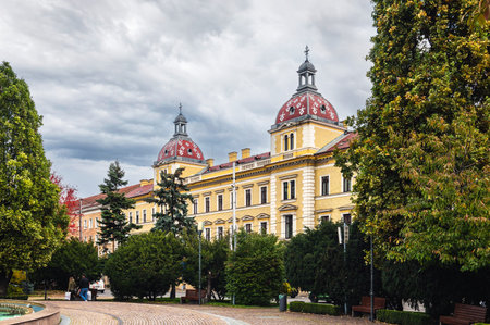Cluj-Napoca, Romania - October 18.2025. A panoramic view of vibrant 19th-century buildings, yellow and pink facades, and urban traffic in the central district of Cluj-Napocaのeditorial素材