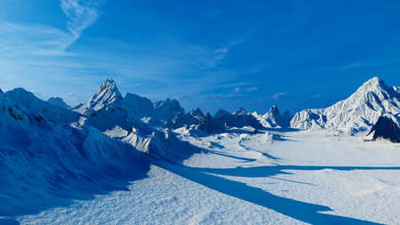 Snowy mountain peak with blue sky and white cloudsの写真素材