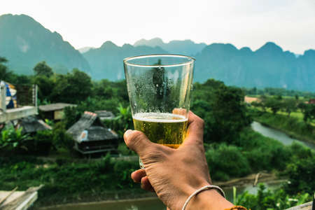 Have a good beer in the good view of mountain, river and mist at Lao PDRの写真素材