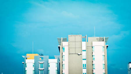 A modern condominium on the blue sky background.の写真素材