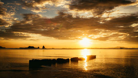 Sunset on the sea in golden skyの写真素材