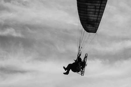 The man riding paramotor in the skyの写真素材