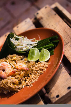 Traditional Thai cuisine Pad Thai on brown plateの写真素材