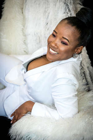 Black African beautiful female portrait wearing a white business suitの写真素材