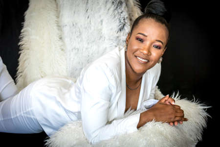 Black African beautiful female portrait wearing a white business suitの写真素材