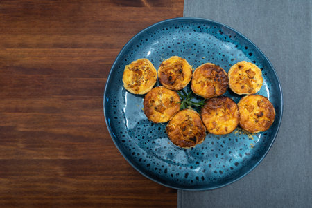 Fried eggplants on a blue plate on a wooden table