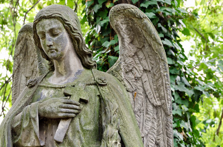 Weathered statue of an Angel - tombstone - old Prague cemetery, Czech republic, Europeの写真素材
