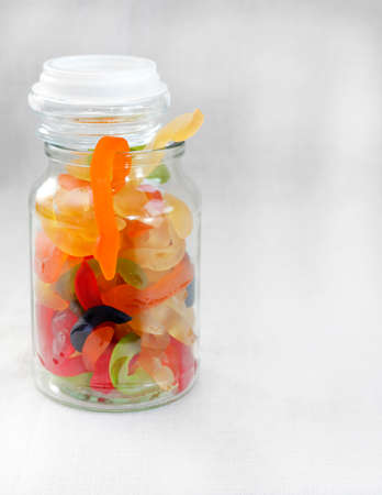 glass jar of gummy snakesの写真素材