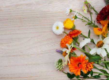 mixture of wildflowers on rustic surface with copy space