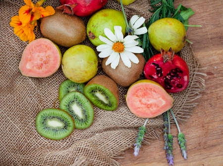 guava and other fruit on rustic wooden tableの写真素材
