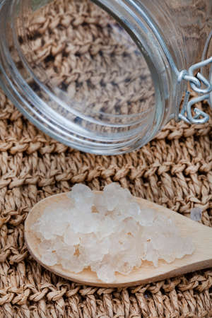Water Kefir grains on wooden spoon with rustic background