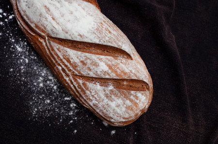 Loaf of fresh Rye bread on rustic background with copy spaceの写真素材
