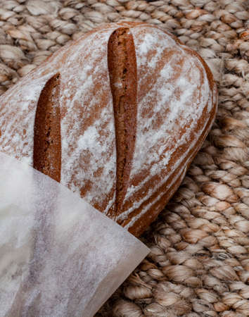 Loaf of fresh Rye bread on rustic background with copy spaceの写真素材