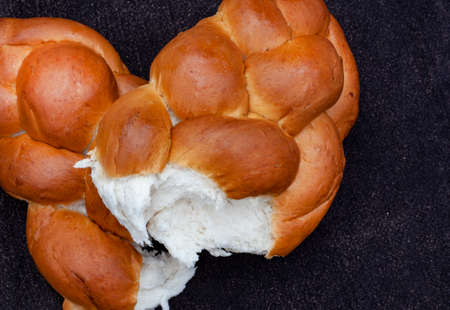Challah or braided bread on rustic surface