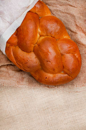 Challah or braided bread on rustic surface
