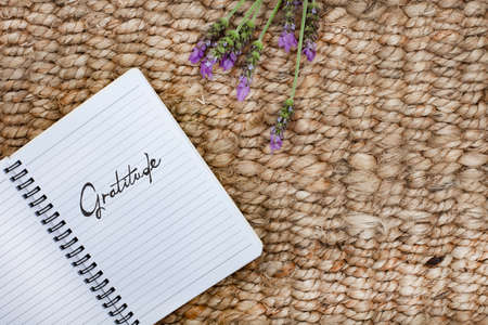 Notebook with the word Gratitude written on it. Placed on a rustic surfaceの写真素材