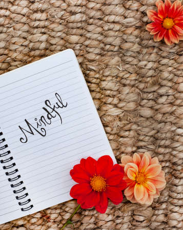 Notebook with the word mindful written on it. Placed on a rustic surfaceの写真素材