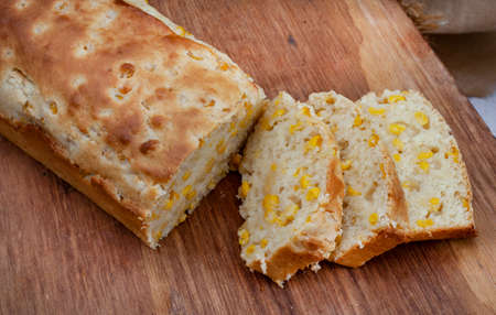 Mielie bread, a South African bread with whole sweetcorn on rustic farm table