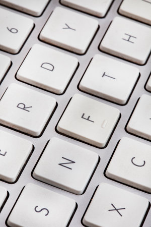 Non-fungible token or NFT concept, NFT spelled out on computer keyboardの写真素材