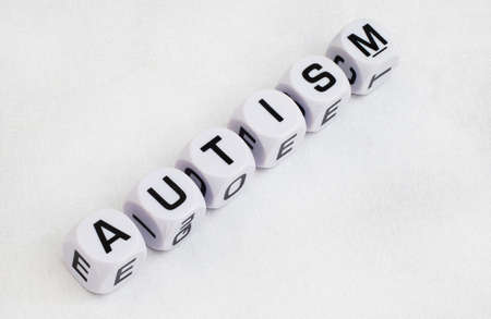 Autism written in letter dice with puzzle pieces