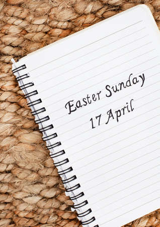 Easter Sunday 17 April handwritten on a notebook with rustic backgroundの写真素材