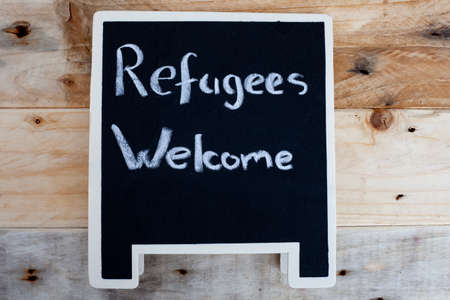Refugees welcome handwritten on a chalkboardの写真素材