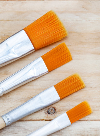 rustic surface with new and clean, soft bristled paintbrushes and ample copy spaceの写真素材