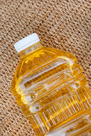 Top part of a 2litre bottle of sunflower cooking oil on rustic surface with copy spaceの写真素材