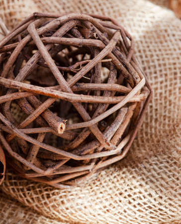ball made of dried twigs as organic decorative item on hessian wit mottled sunlight and copy spaceの写真素材