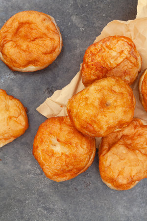 South African vetkoek, deep fried savory dough, on mottled grey background with copy space