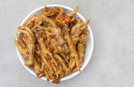 South African township delicacy, cooked chicken feet or walkie talkies with onion and sauceの写真素材