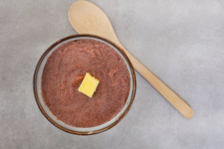 Traditional  African Sorghum breakfast porridge or Mabele, on mottled grey with copy space