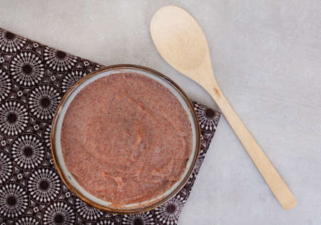 Traditional  African Sorghum breakfast porridge or Mabele, on mottled grey with copy space